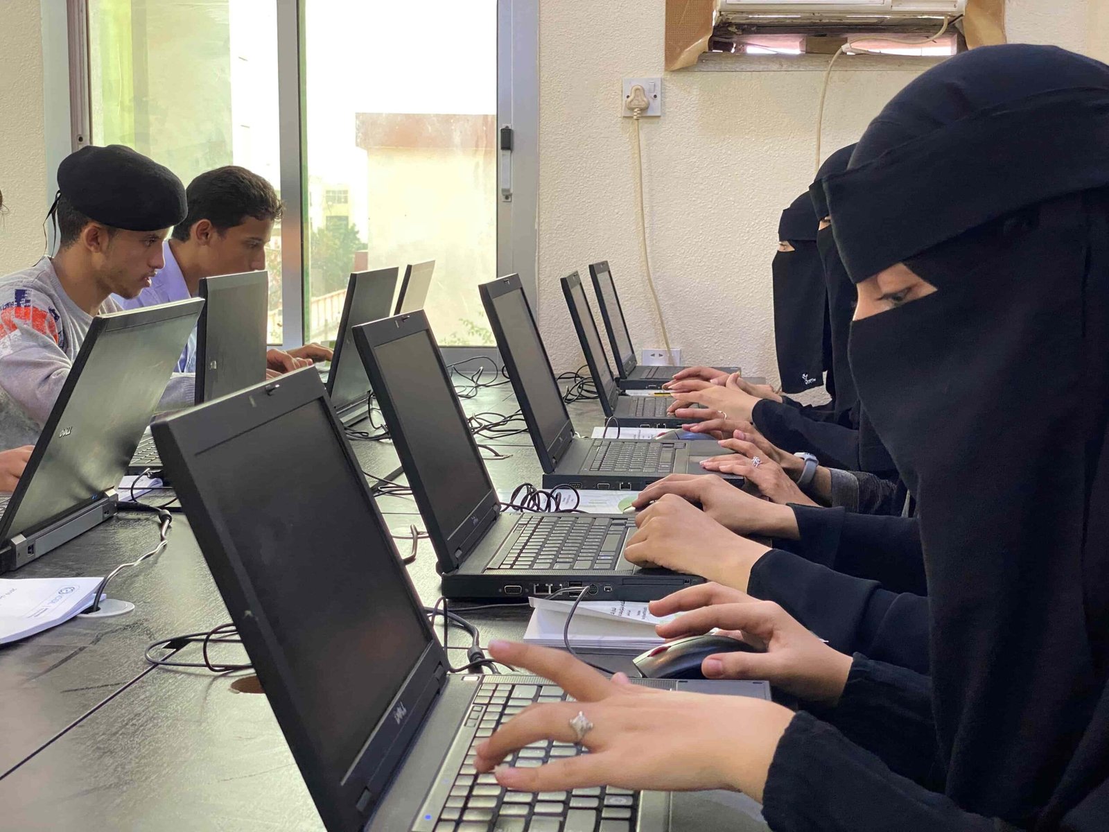Students practising computer skills at Cambridge Aden Institute